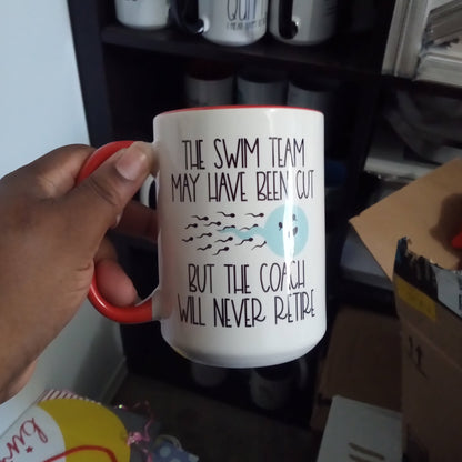 The Swim Team May Have Been Cut But The Coach Will Never Retire  (15oz red inner/handle mug w/imperfections)