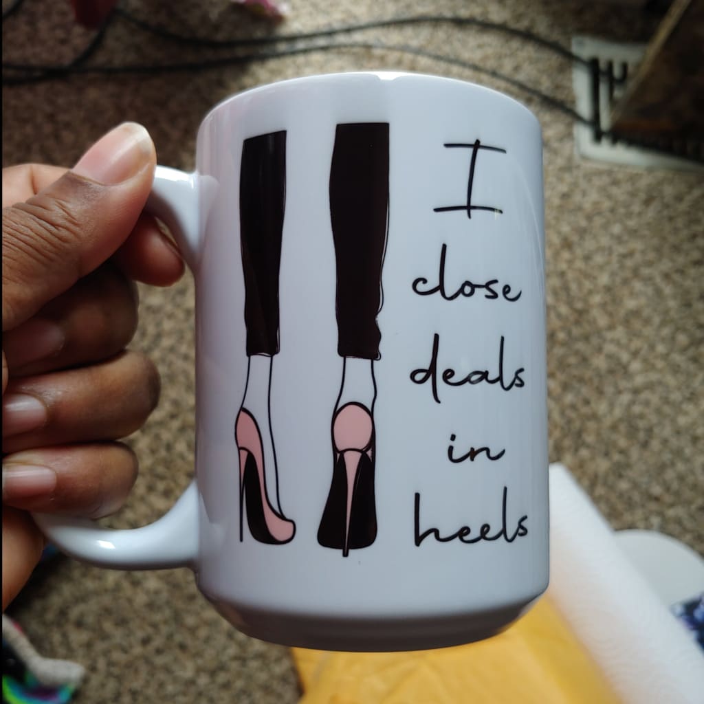 I Close Deals In Heels (15oz white mug w/shadowing on one side of the design) TNDCanada
